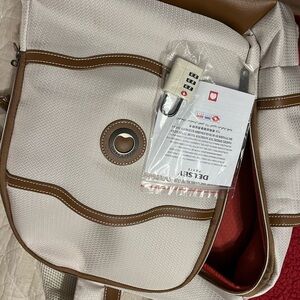 NWOT Delsey back pack cream color with brown leather trim.